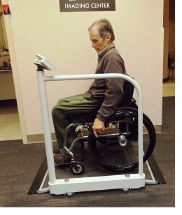 bob, a wheelchair user, moves onto an accessible scale