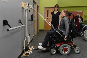 a woman wheelchair user pulling cables for resistance training