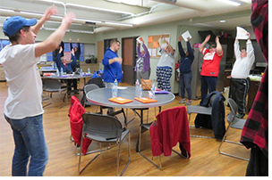 participants wave their hands in the air, playing a game