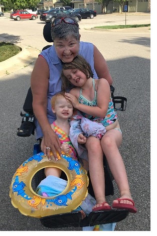 deb young with her grandkids outside