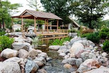 bubbling brook and big boulders before a gazebo. 