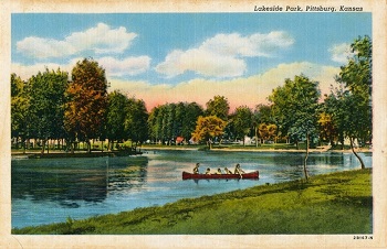 people canoeing on a pond
